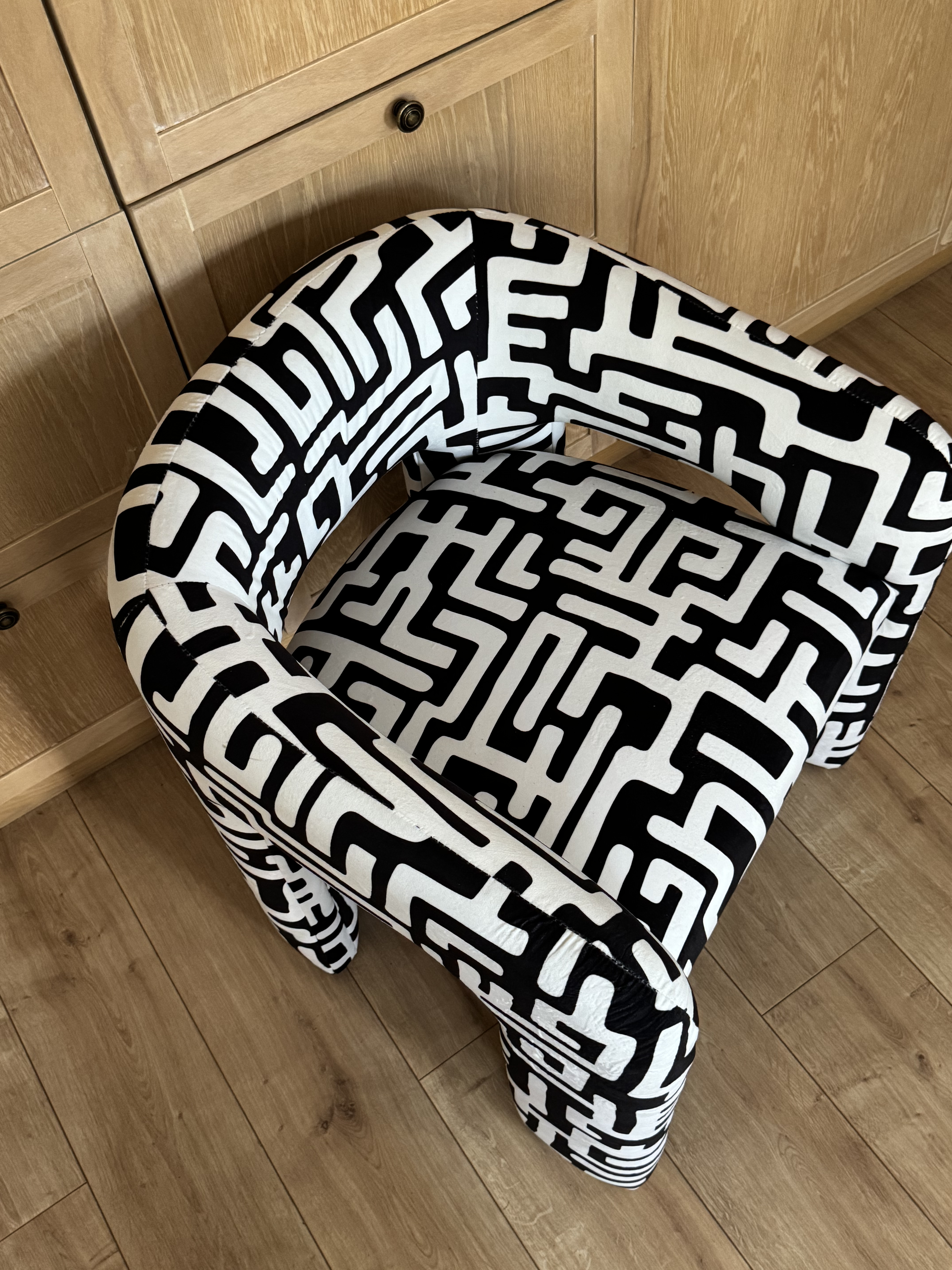 Custom L-shaped sofa with bold print rug
